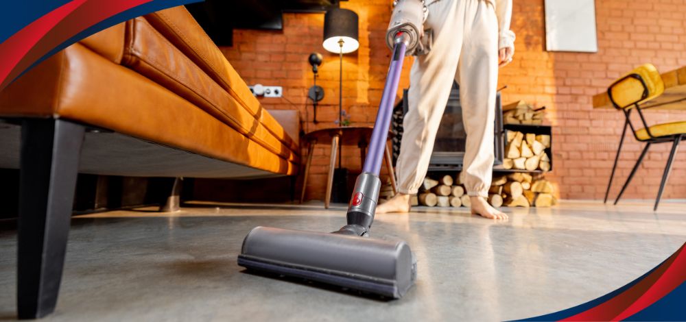 A woman using a cordless vacuum cleaner in the Philippines to clean remote areas in her home