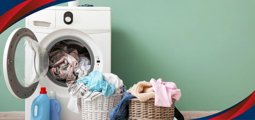Whirlpool washing machine in the Philippines with baskets of dirty laundry.